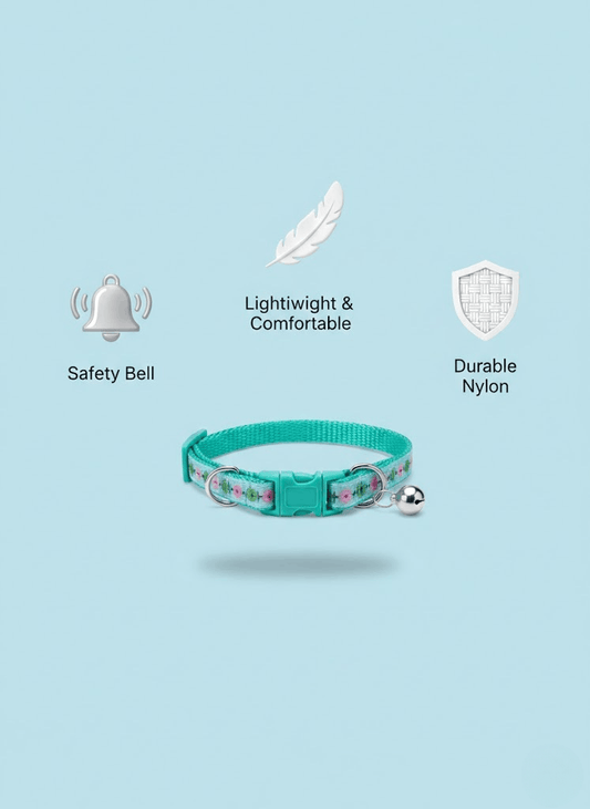 Teal cat collar with safety bell on a light blue background