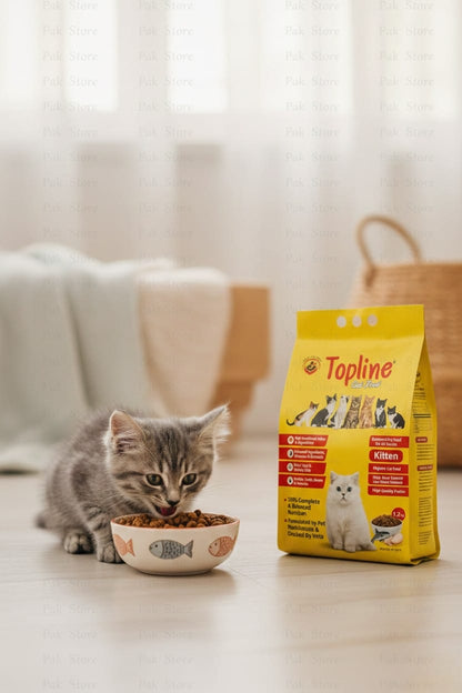 Kitten eating from a bowl of Topline cat food with the packaging in the background.